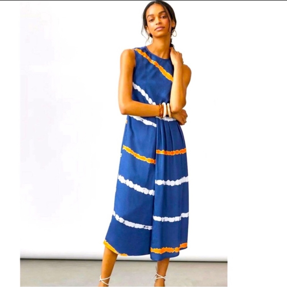 Navy sleeveless midi dress with orange and white designs.